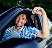 Man sitting in car holding car keys